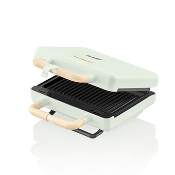Torradeira verde para um toque mais moderno e com placas substituíveis para preparação de outras refeições.
